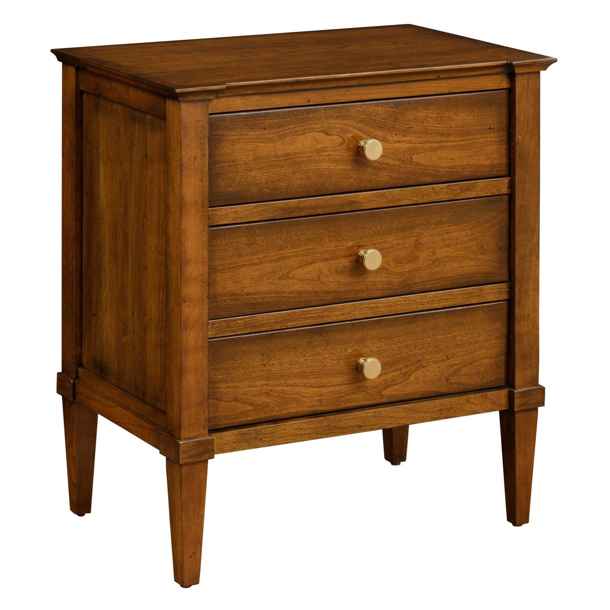 Three-drawer cherry night table with brass knobs, recessed side panels and square tapered legs on a white background