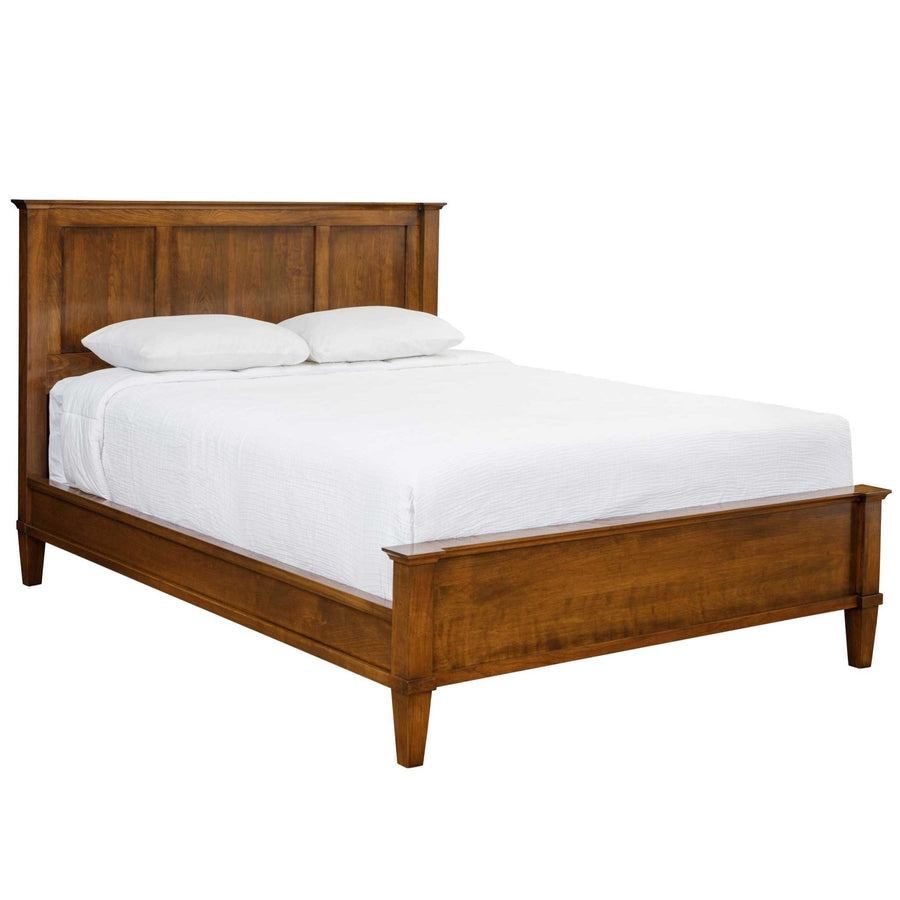 Cherry panel bed with three-panel headboard, matching low footboard and tapered legs, made up in white bedding on white