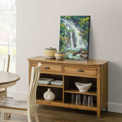 Honey oak 50 inch open buffet with two drawers, four open shelf compartments and dishes on display