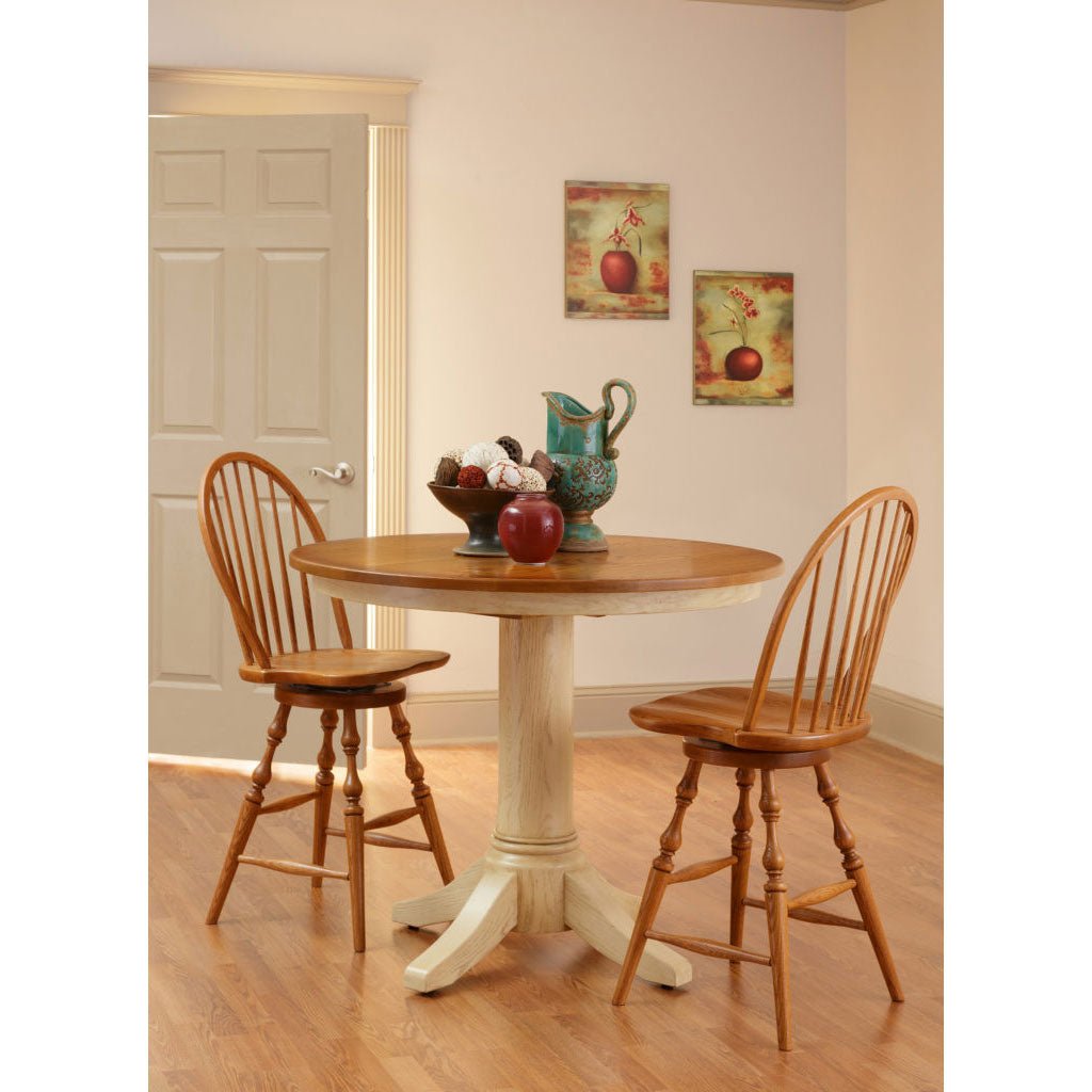 Two tone pub table with oak top and white pedestal, paired with bow back oak swivel stools in a corner
