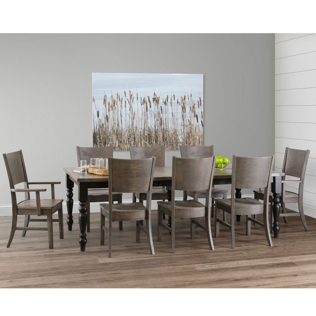 Gray weathered dining set with a turned leg table, seven side chairs and one arm chair in a shiplap room