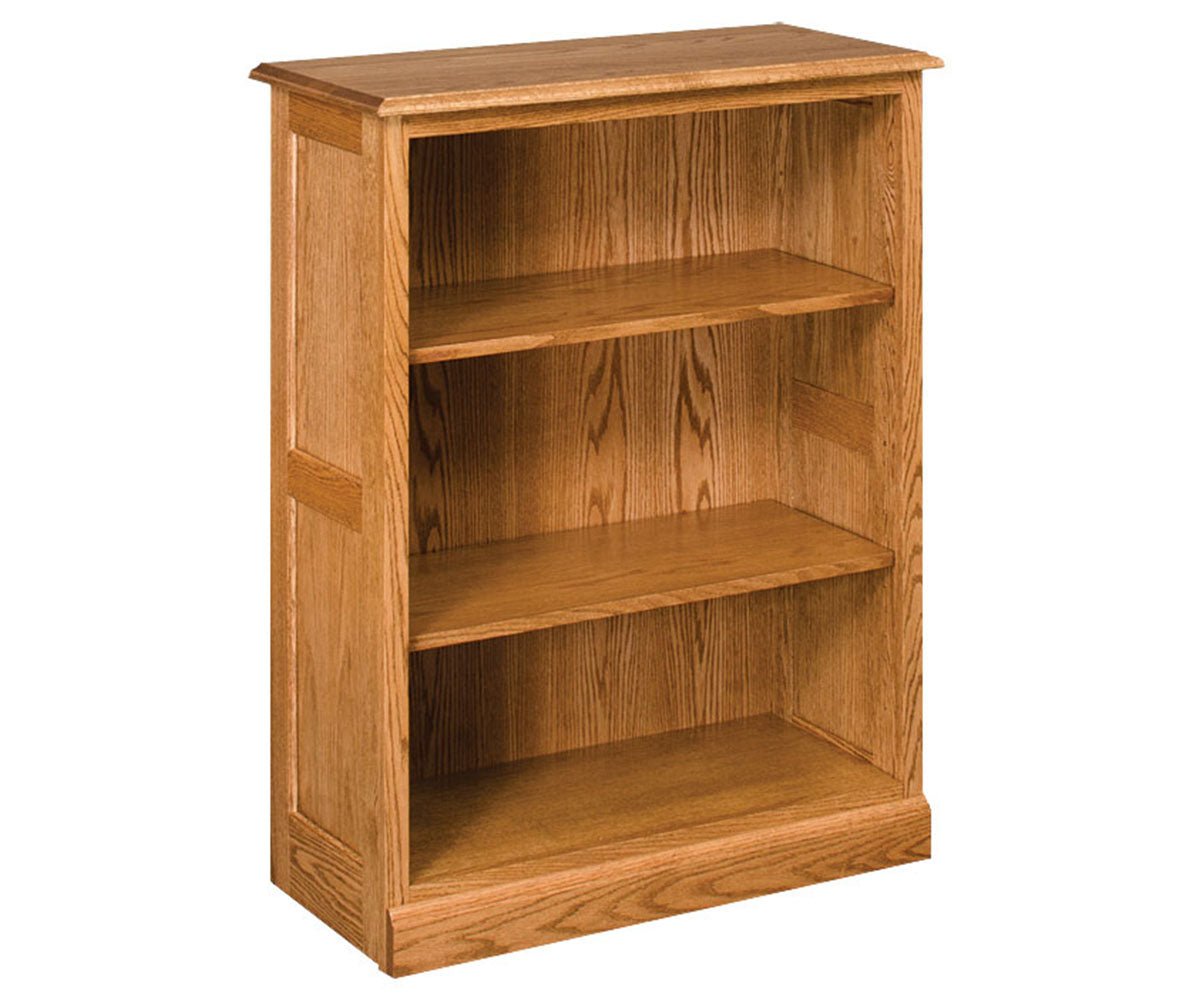 Three-shelf solid oak bookcase with adjustable shelves, raised panel side, beveled top and recessed base molding
