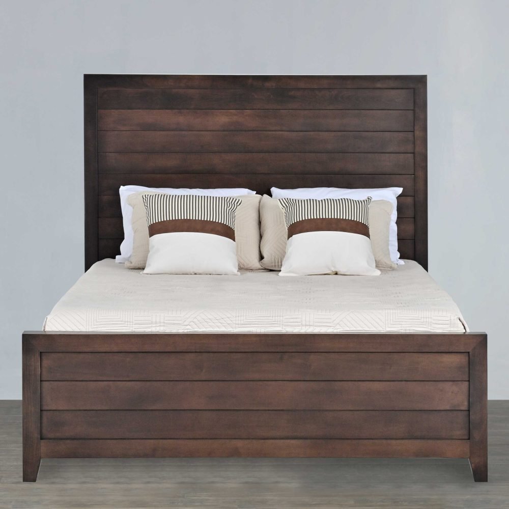 Queen panel bed with a tall shiplap plank headboard in dark brown wood, striped pillows and cream quilted bedding