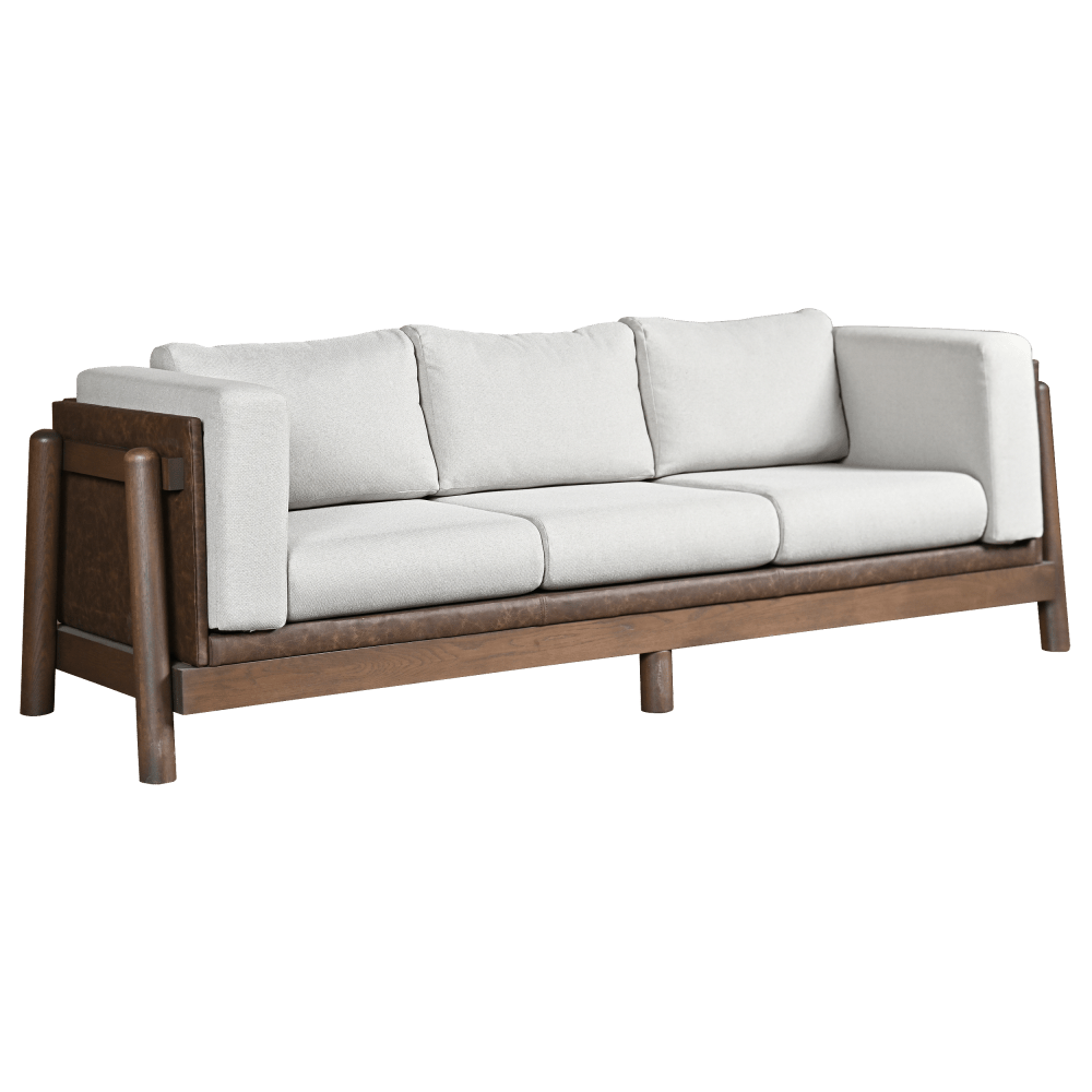 Mid century modern sofa with white cushions and a walnut wood frame in a navy paneled living room with bookcases