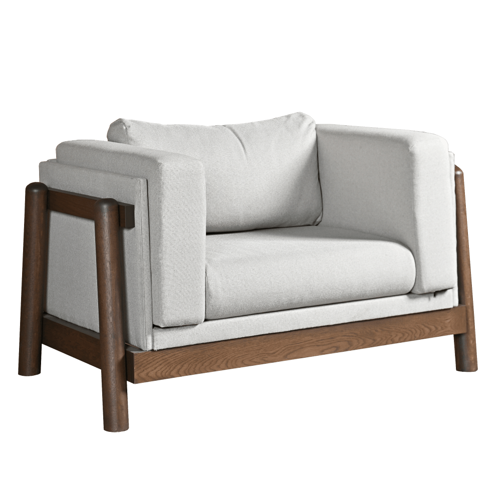 Wide lounge chair with white cushions and a walnut frame beside a plank coffee table in a dark paneled living room