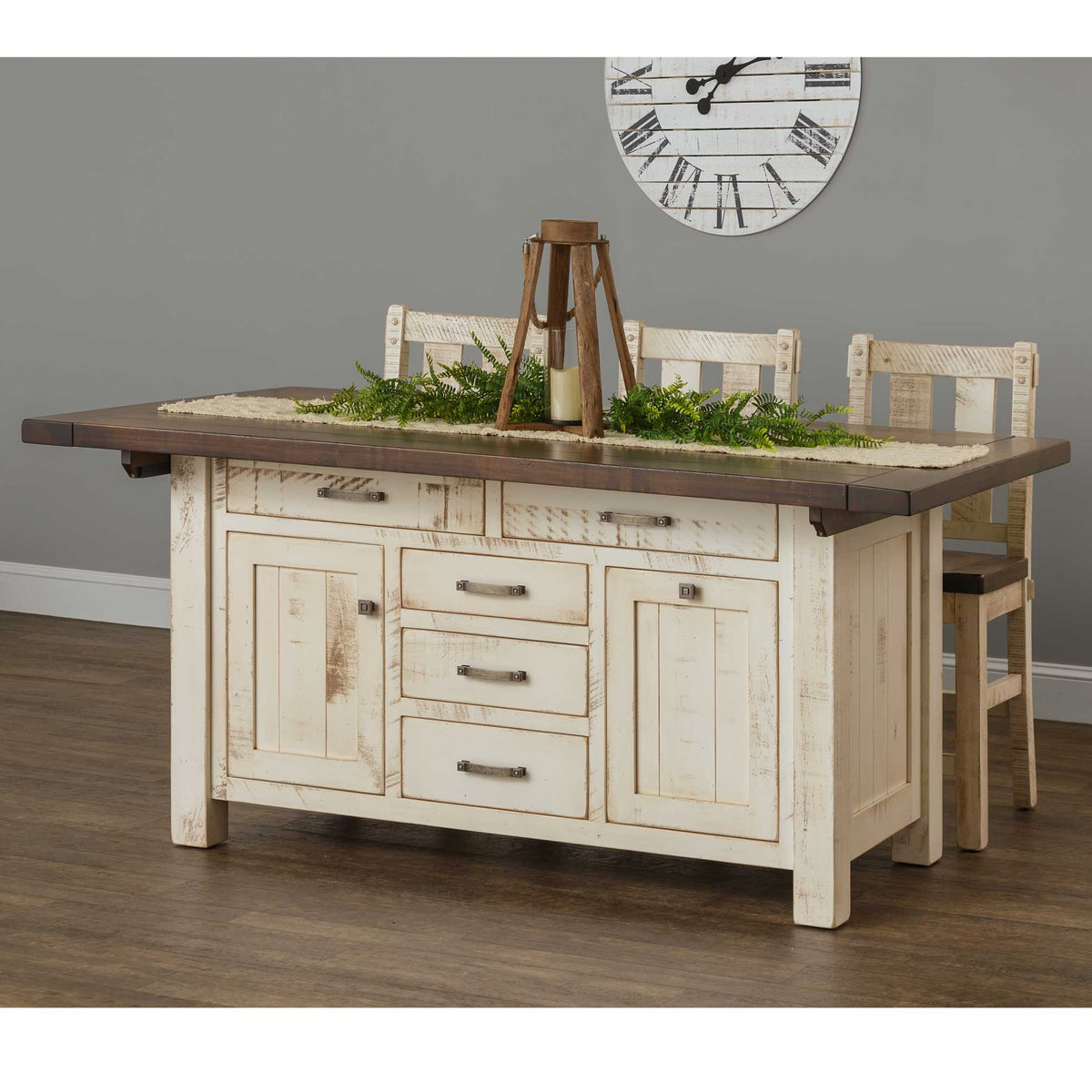Expandable kitchen island in distressed white with a dark plank top, drawers, doors and three bar chairs