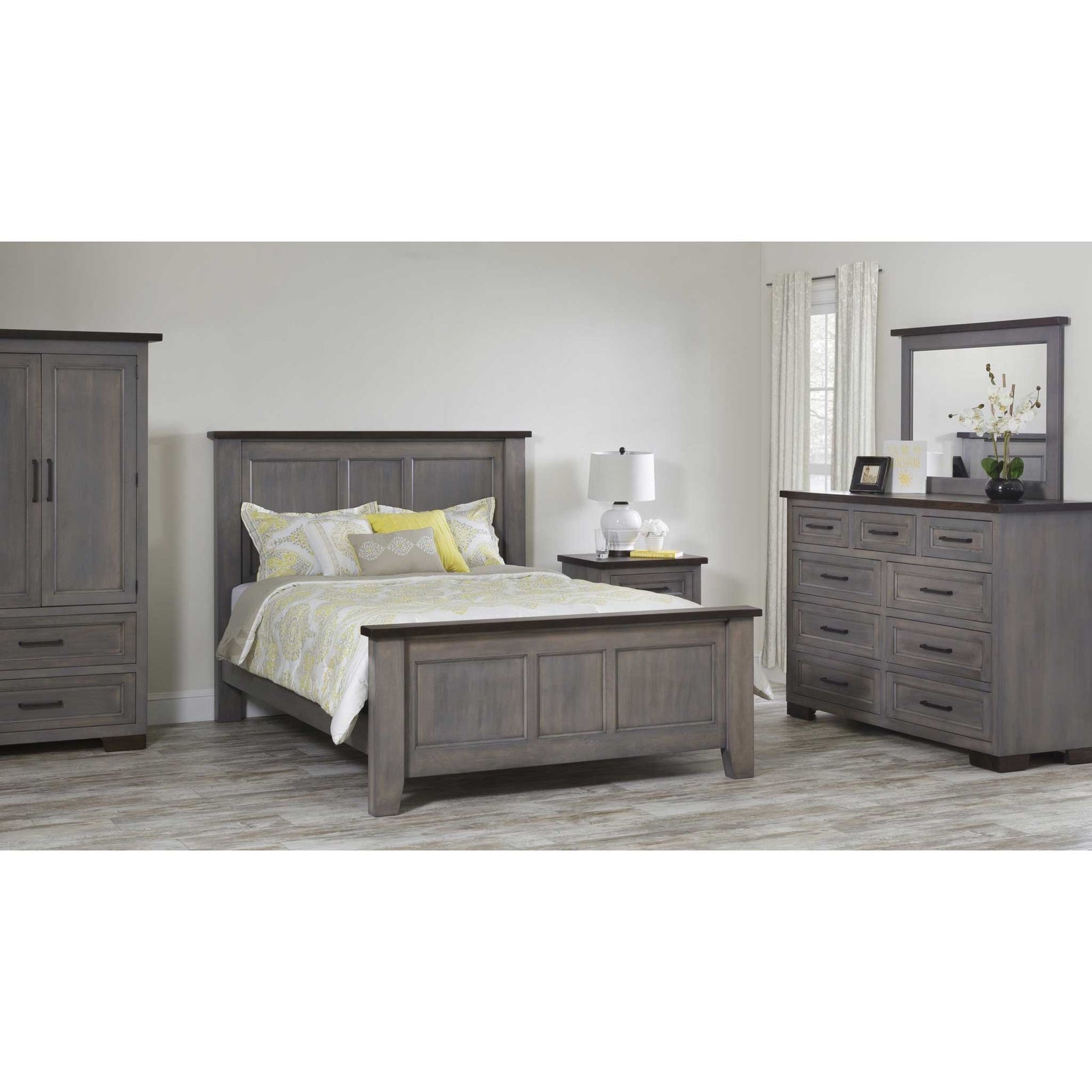 Gray bedroom set with panel bed, armoire, nightstand and mirrored dresser in a bright neutral room