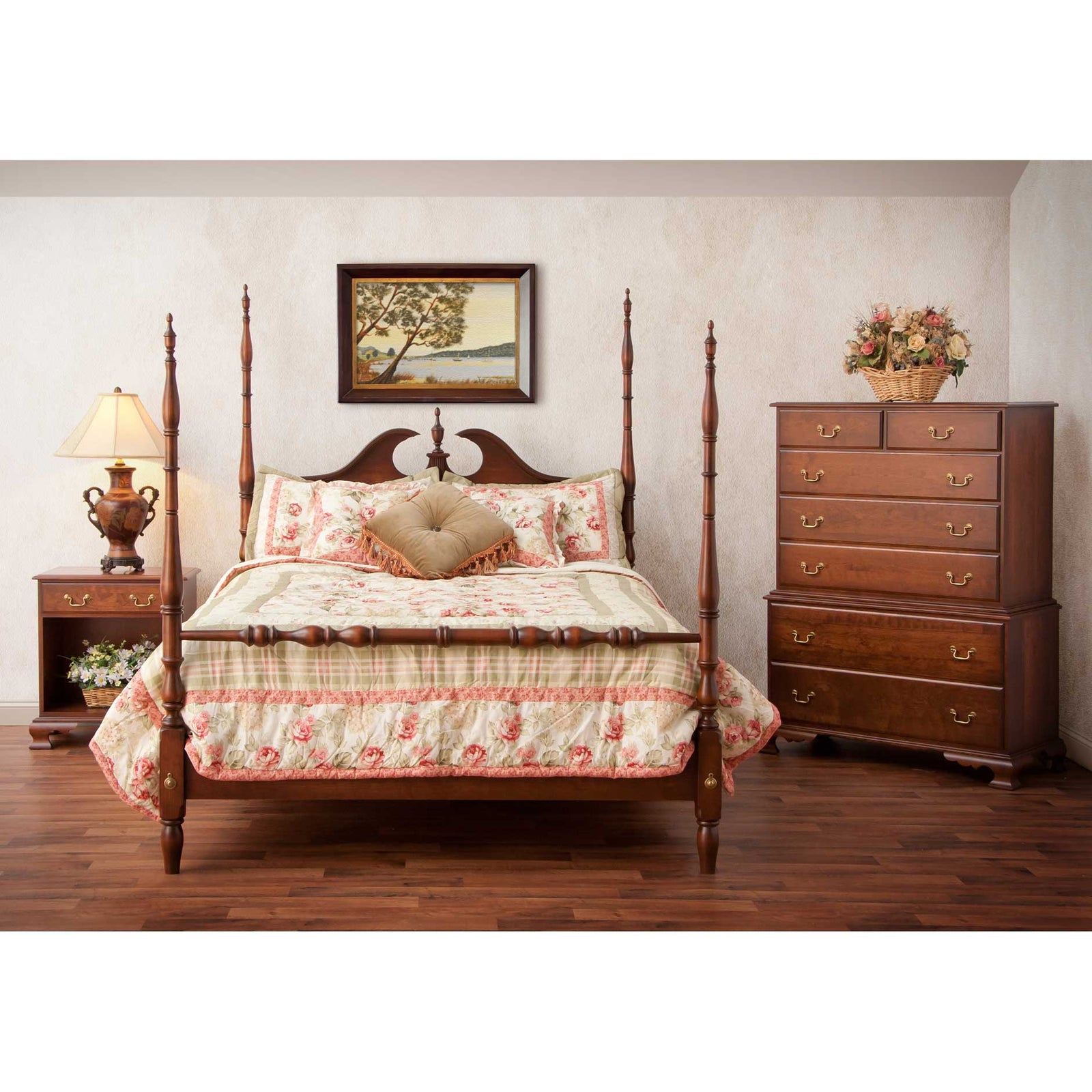 Cherry poster bedroom set with a broken-arch pediment bed, floral quilt, nightstand and seven-drawer chest of drawers