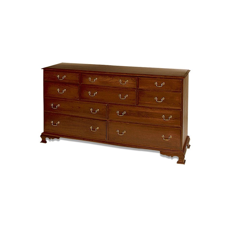 Ten-drawer cherry triple dresser with brass bail pulls, molded top and a scalloped ogee bracket base on white