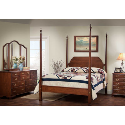 Cherry pencil post bedroom set with a tall four-post bed, patchwork quilt, triple dresser with triview mirror and nightstand