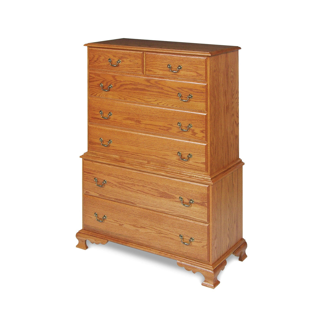 Seven-drawer chest on chest in golden oak with antique brass bail pulls, waist molding and ogee bracket base
