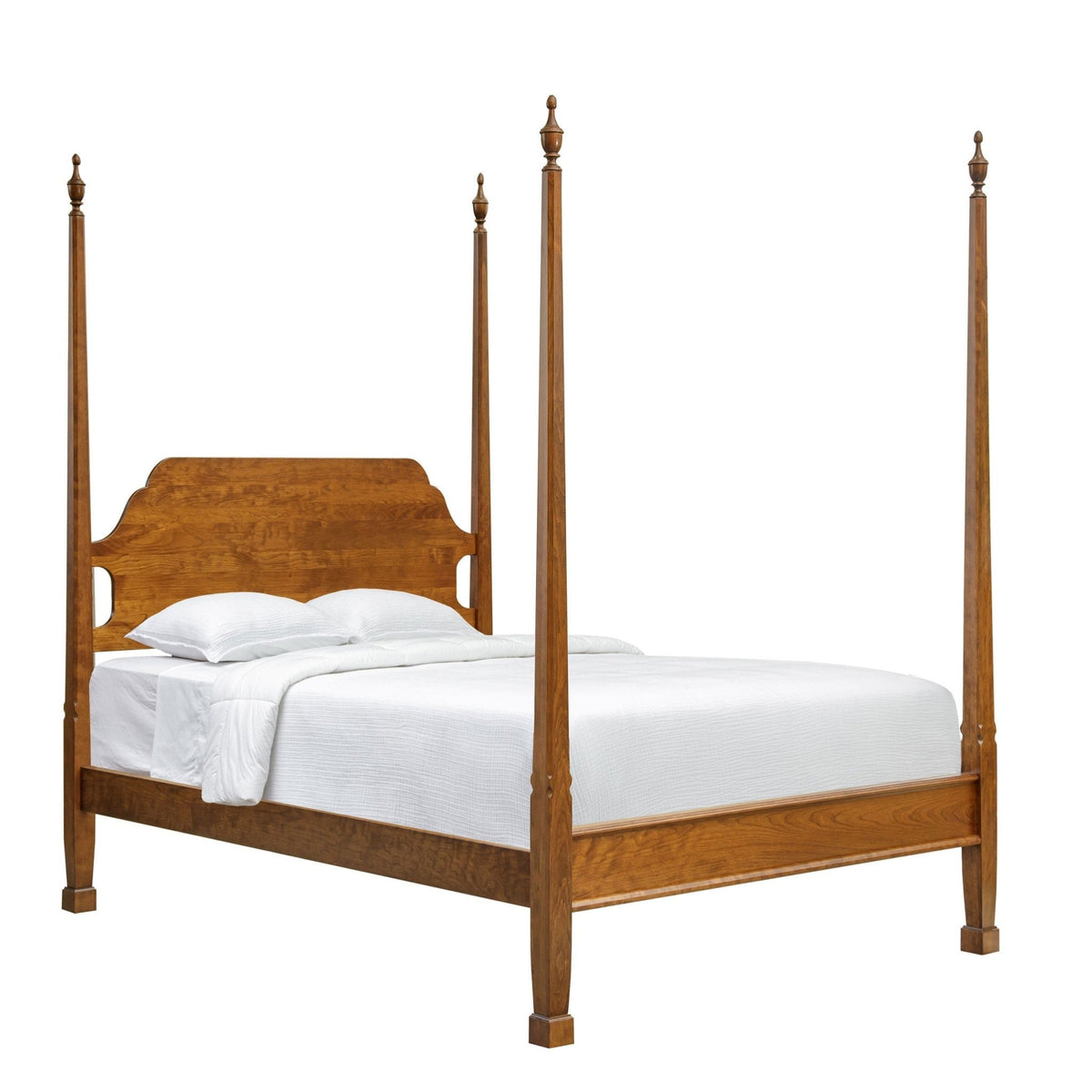 Four-post pencil bed in cherry with arched headboard, urn finials and white bedding on a white background