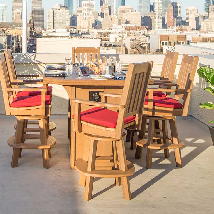 Six cedar poly swivel bar chairs with red cushions around a rooftop fire table above the city skyline