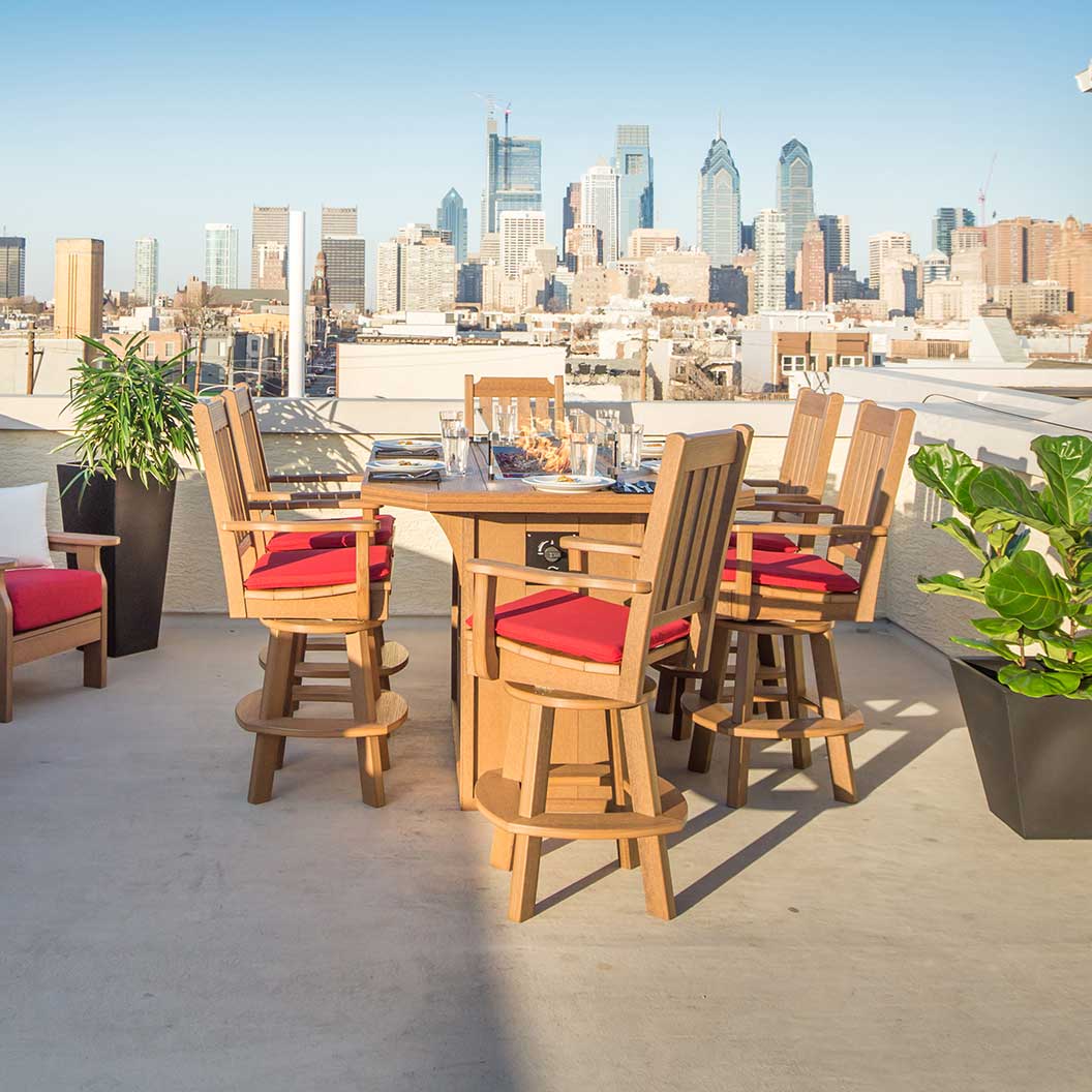 Cedar poly swivel bar chairs with red cushions around a tall pub table on a city rooftop deck