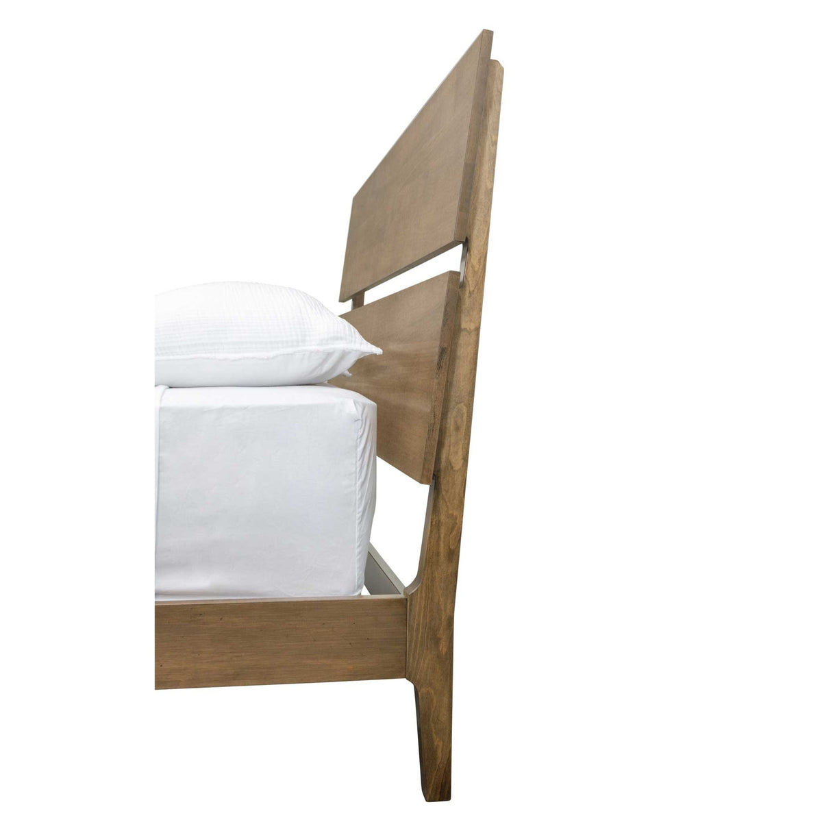 Side profile of the mid century bed showing the raked headboard panels and low rail with white bedding