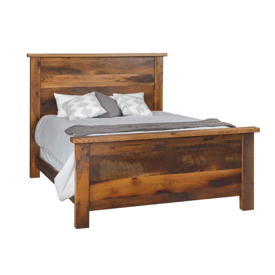 Reclaimed barnwood panel bed with wide plank headboard and footboard in a warm honey finish with gray bedding