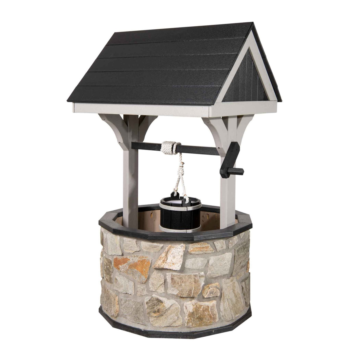 Stone wishing well with black shingled roof and gray posts, rope bucket and black crank handle, isolated on white