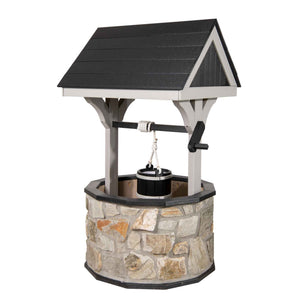 Stone wishing well with black shingled roof and gray posts, rope bucket and black crank handle, isolated on white