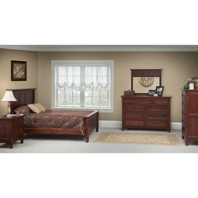 Cherry bedroom set in a tan bedroom: panel bed, nightstand, nine-drawer dresser with mirror and tall chest of drawers