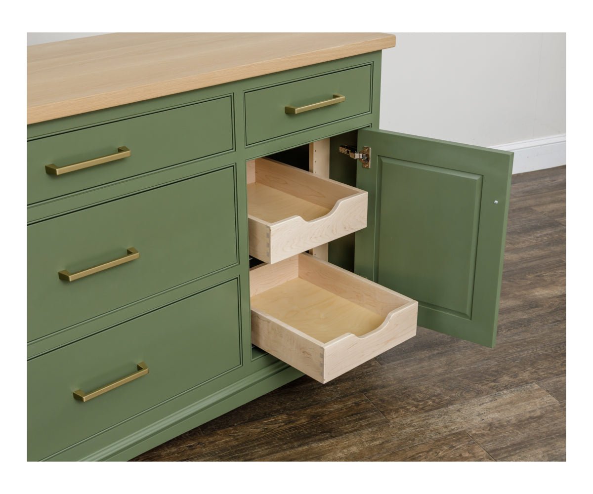 Green sideboard with a cabinet door open, revealing two maple roll-out shelves behind the paneled door