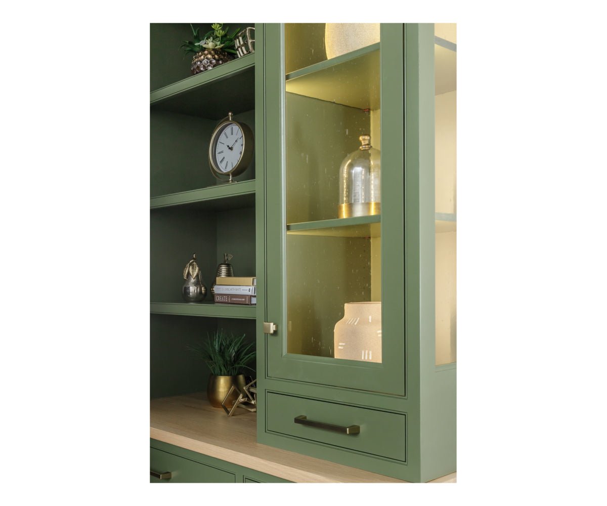 Close-up of the hutch's lighted glass door, brass hardware, adjustable shelves and oak serving surface