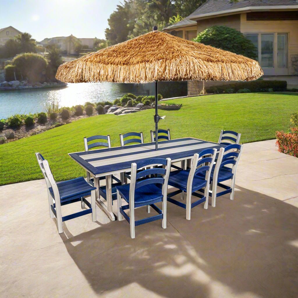 An outdoor dining set with a rectangular polyethylene dining table in blue and white stripes, accompanied by six chairs with blue and white striped cushions, and a thatched umbrella. The set is displayed on a white background.