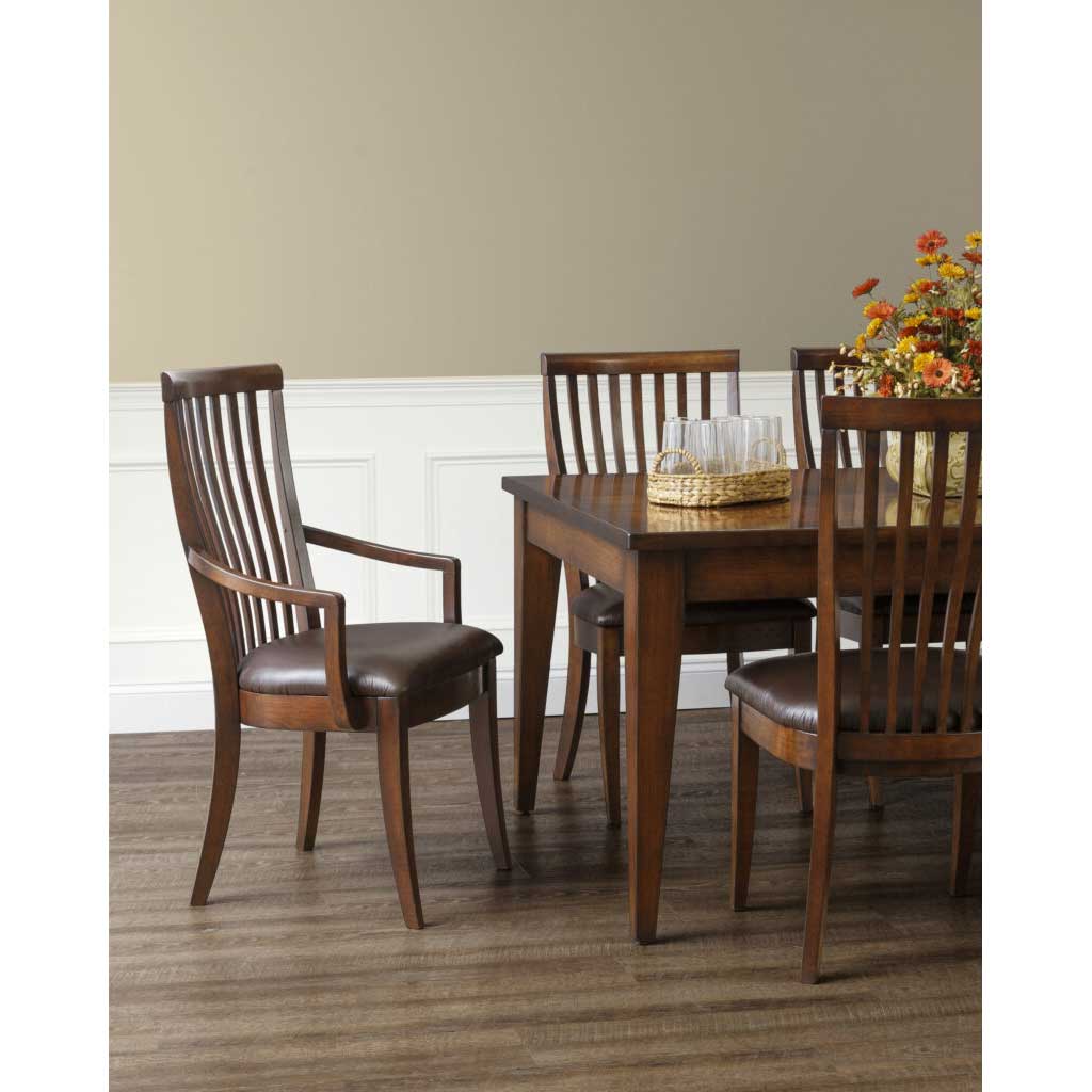 Cherry slat back dining arm chairs with dark brown leather seats set around a rectangular dining table