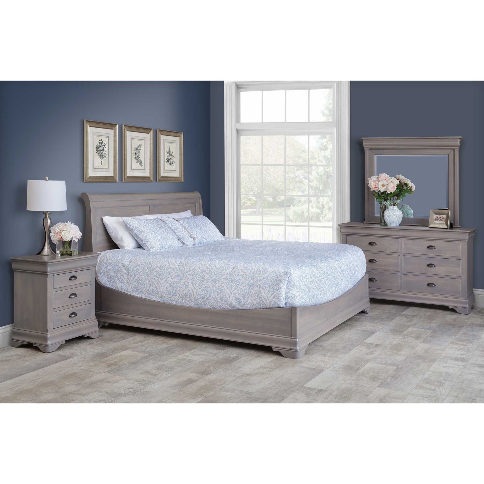 Gray-washed maple bedroom set with a sleigh bed, three-drawer nightstand and dresser with mirror in a navy bedroom