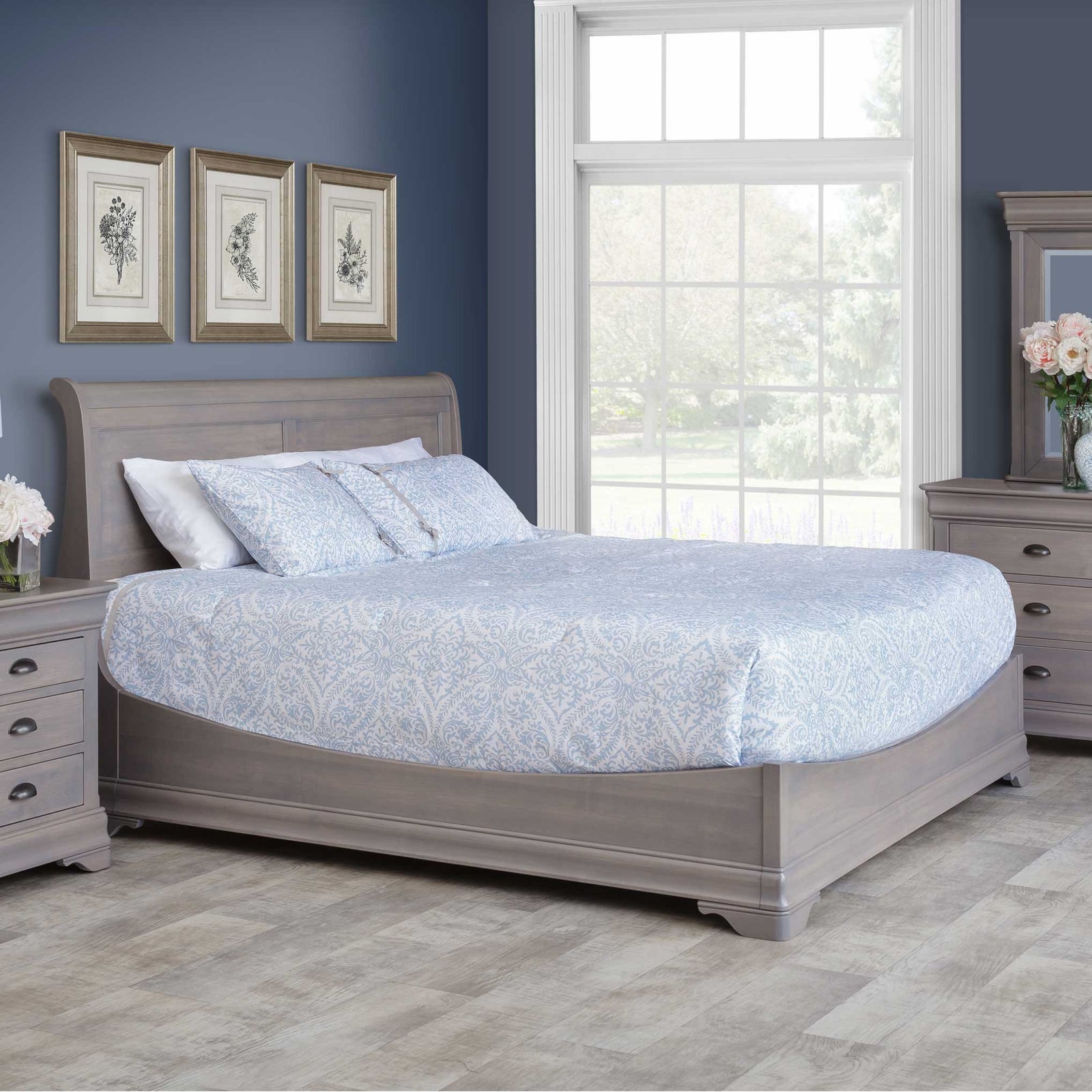 Gray-washed maple bedroom set with a sleigh bed, three-drawer nightstand and dresser with mirror in a navy bedroom