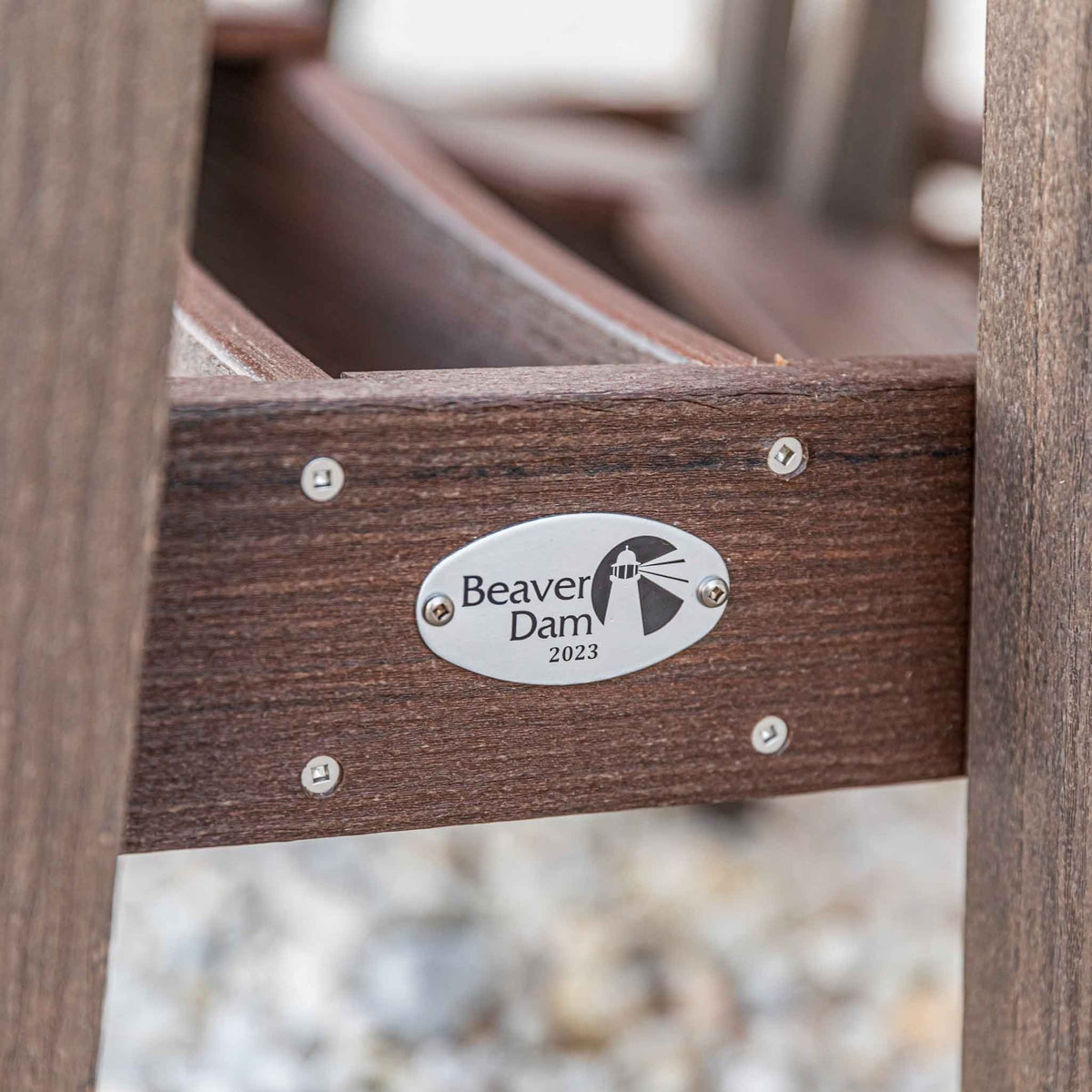 Detail of the Beaver Dam 2023 metal maker plate on the brown poly table frame