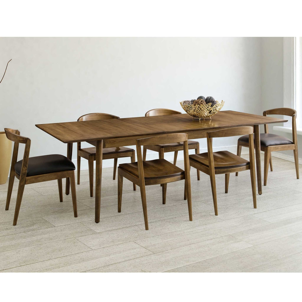 Mid century rectangular dining table in walnut with six curved back chairs and black leather seats