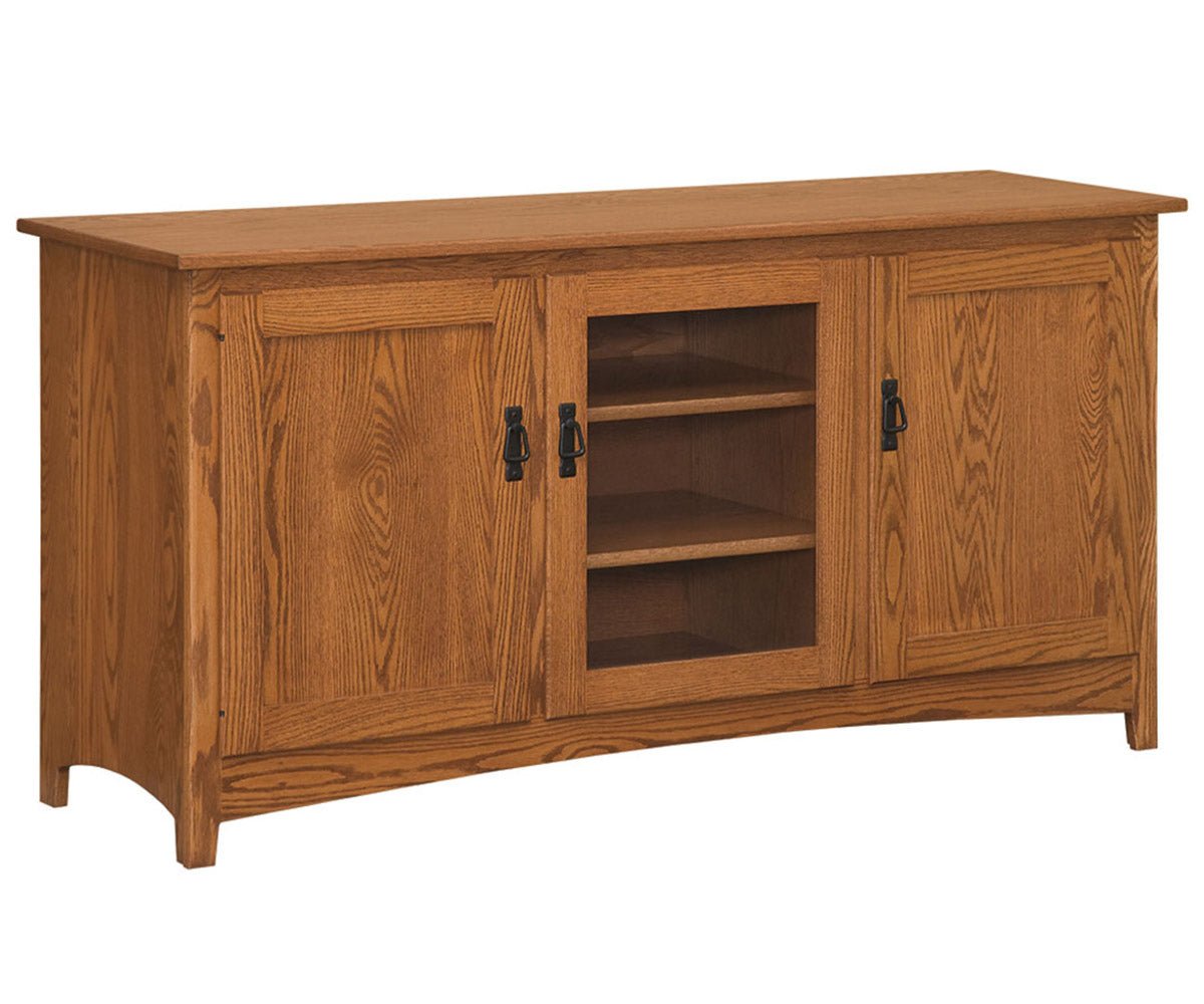 Long Mission oak TV stand with two panel end doors, a glass center door with two shelves and black hardware