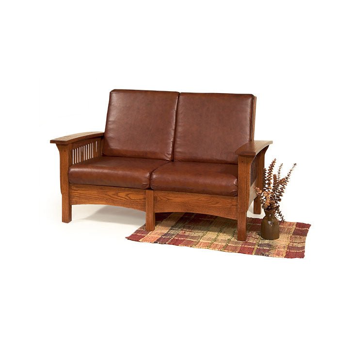 Oak Mission Morris loveseat with brown leather cushions, slat sides, arched front rail and curved arms