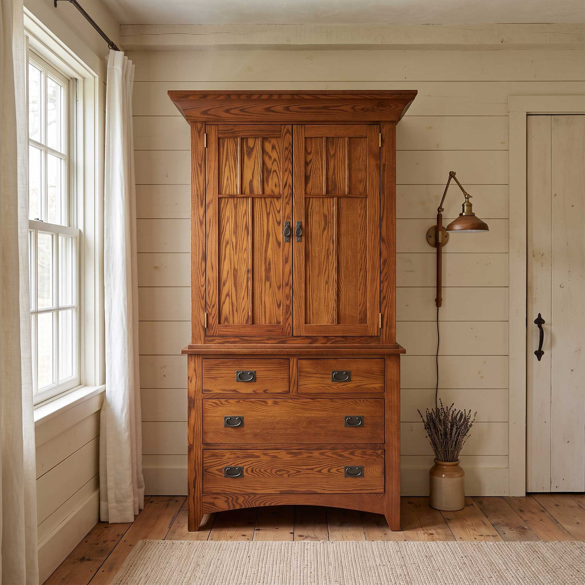 A rustic wooden armoire cabinet with a two-door upper section and three drawers below, styled in a bright, neutral room with a window, wall lamp, and door.