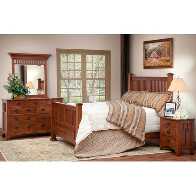 Mission oak bedroom set with slatted bed, matching nightstand and mirrored dresser in a warm styled bedroom