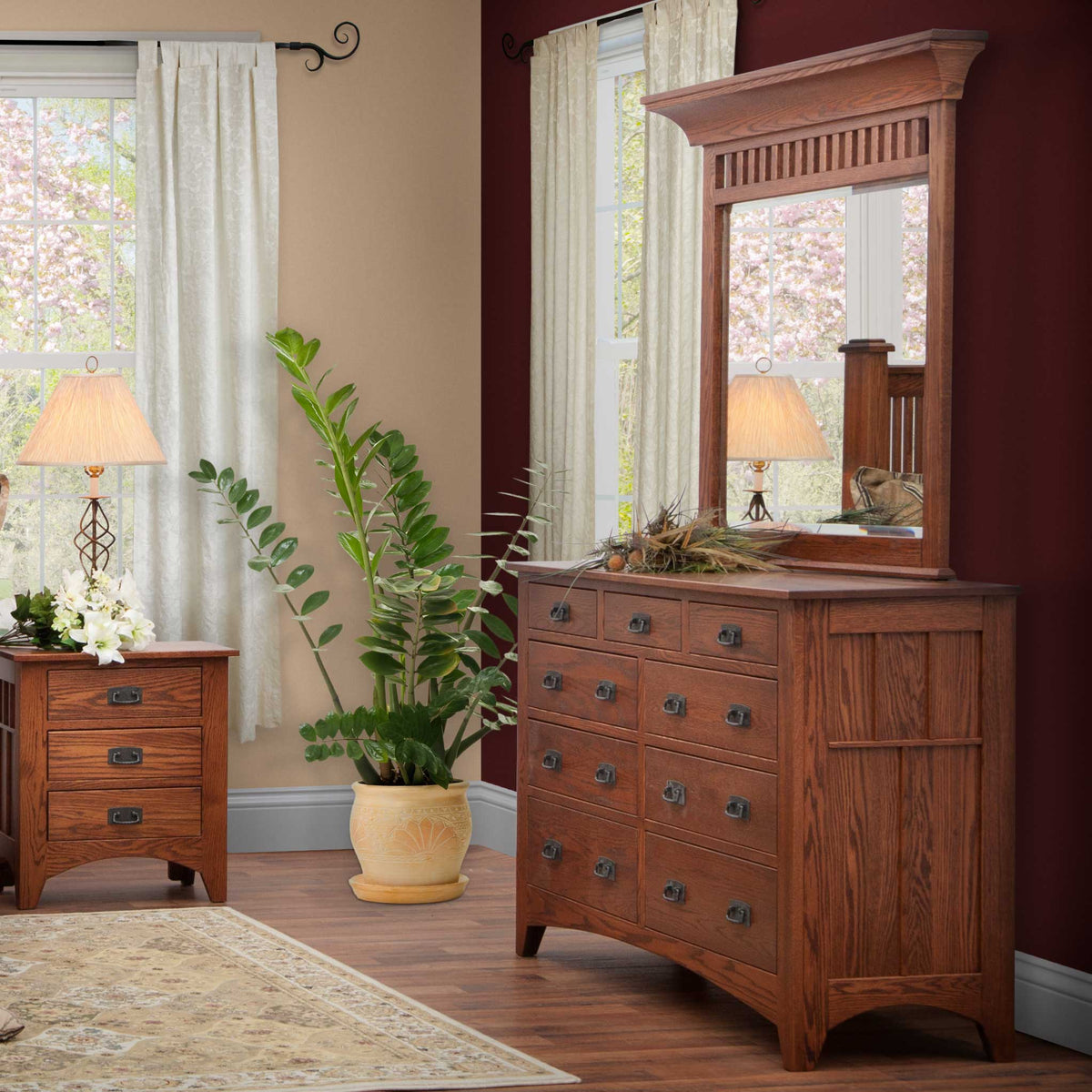 Mission oak dresser with slatted mirror hutch and matching three-drawer nightstand in a bedroom with burgundy accent wall