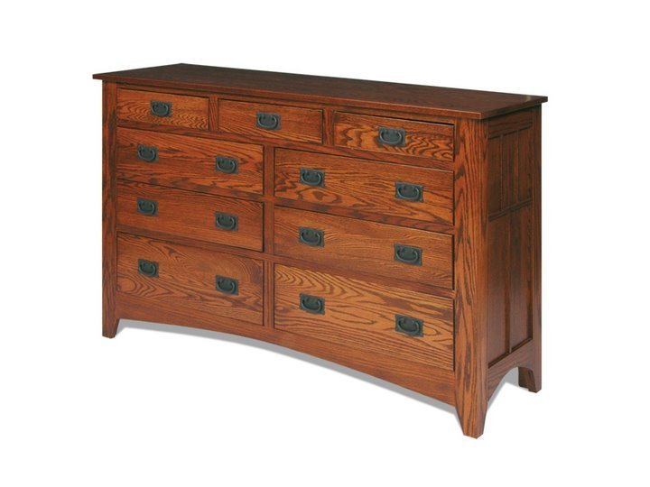Nine-drawer Mission oak dresser with dark bail pulls, paneled sides and a gently arched base on a white background