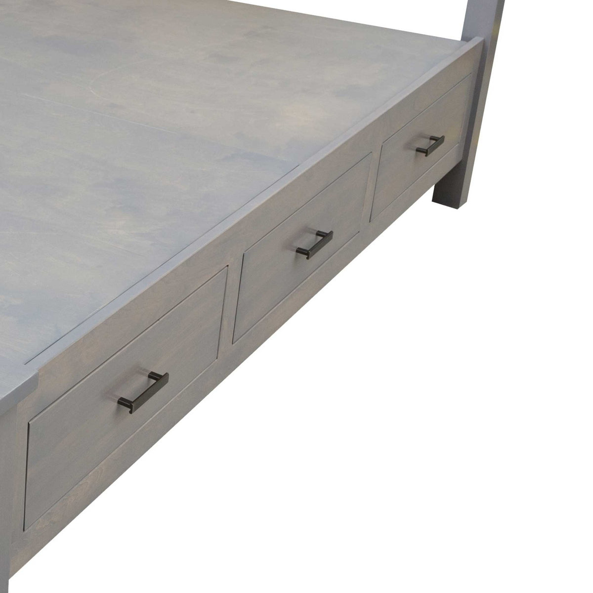 Corner view of the gray platform storage bed showing three drawer fronts with black bar pulls