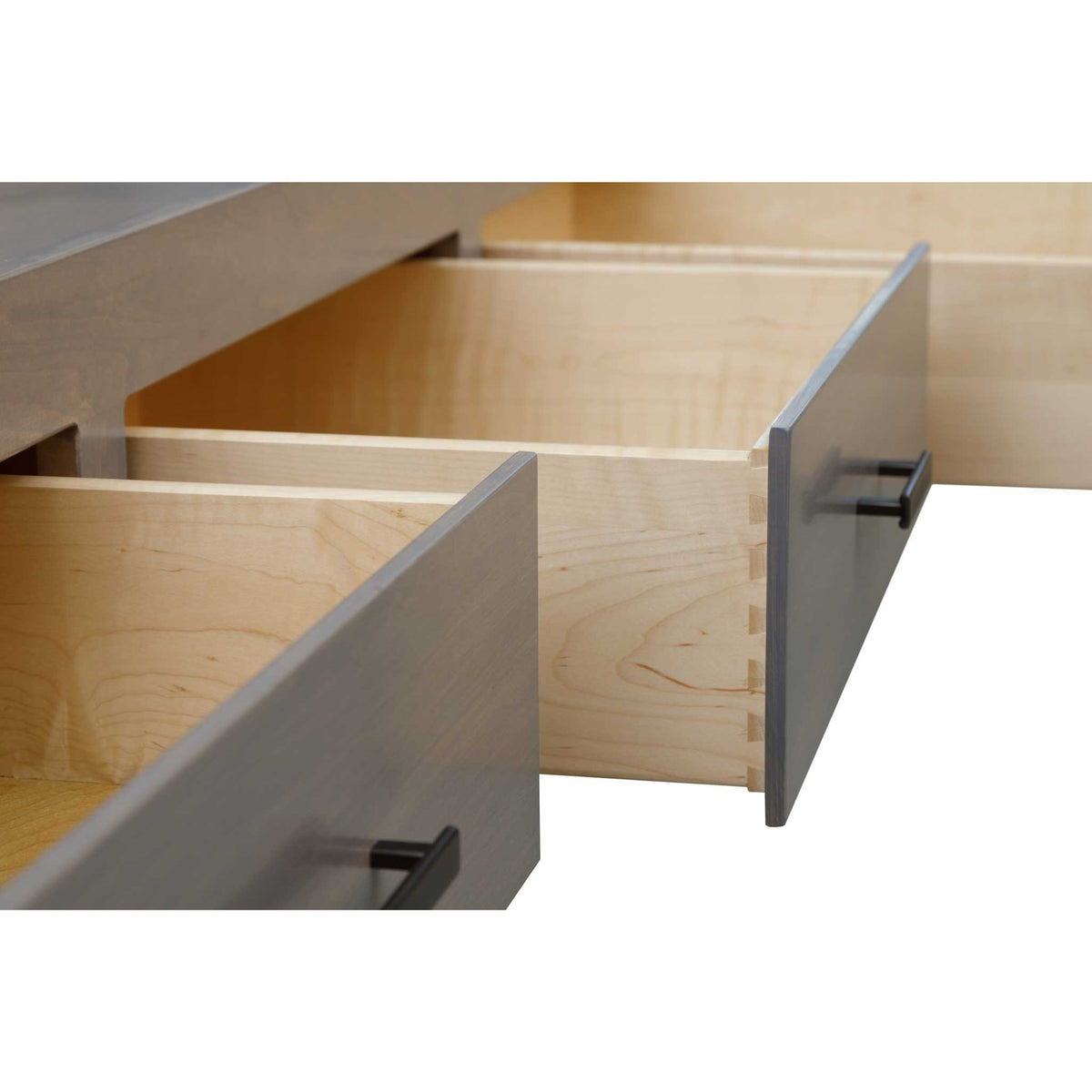 Two storage drawers pulled open on the gray bed, revealing dovetailed maple drawer boxes