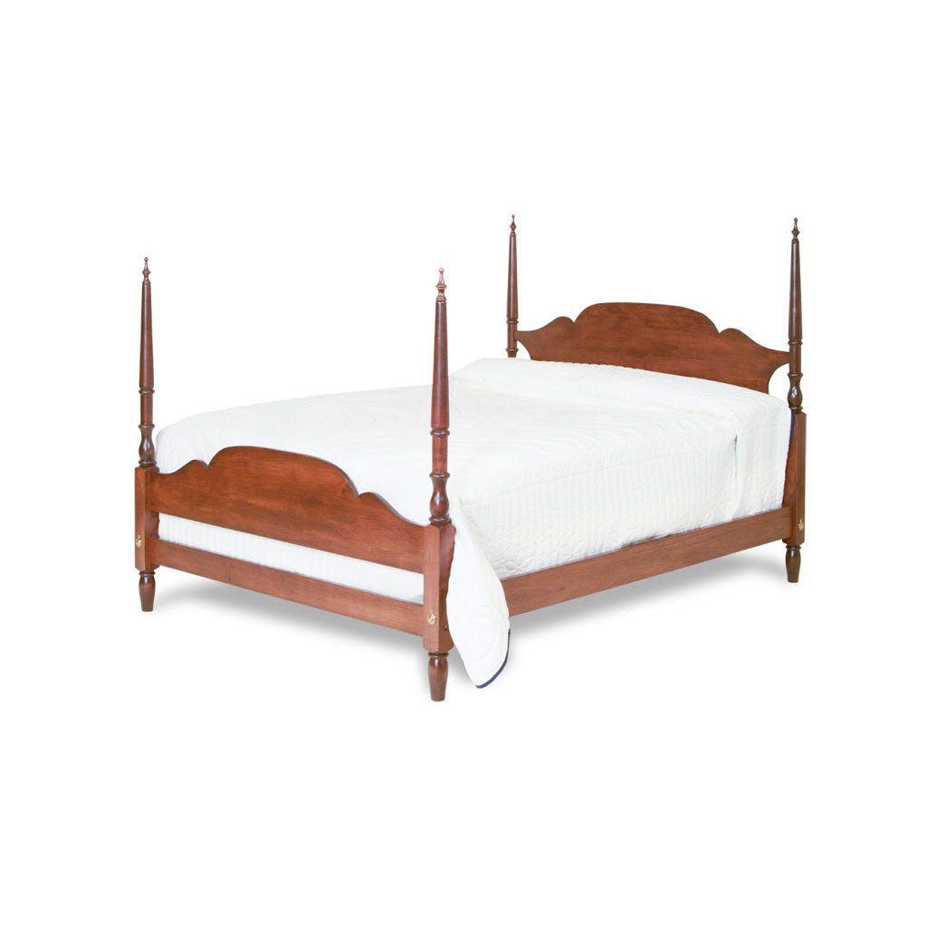 Cherry arch top poster bed with slender turned posts and scalloped footboard, made up in white bedding