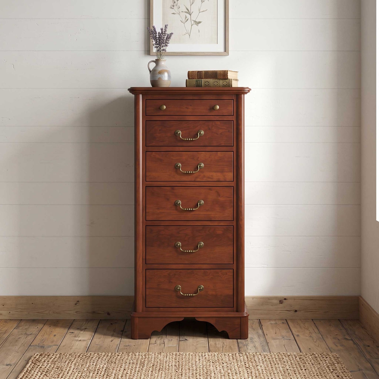 A tall, five-drawer wooden chest of drawers in a warm reddish-brown finish with brass handles, set against a white shiplap wall on a wooden floor with a woven rug.