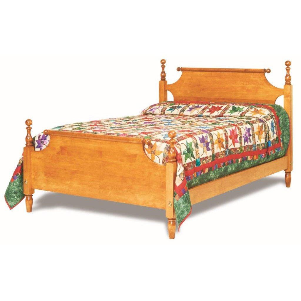 Turned post scroll bed in light maple with acorn finials and paneled footboard, dressed in a star pattern quilt