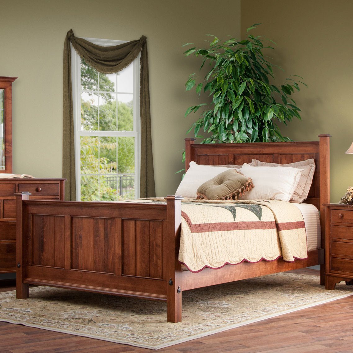 Cherry panel bed with three-panel headboard and footboard, dressed in a star quilt in a green walled bedroom