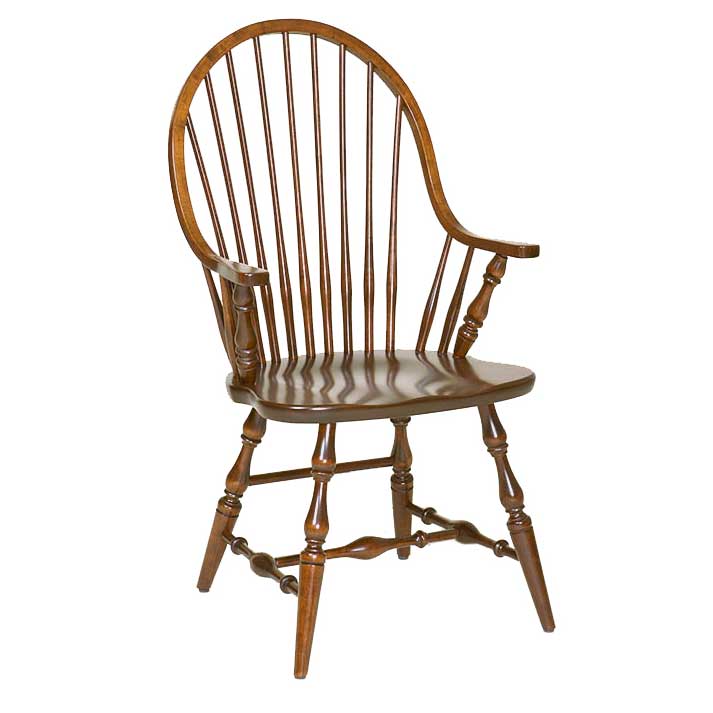 A classic wooden spindle-back chair with turned legs and armrests, shown from a three-quarter angle on a solid white background.