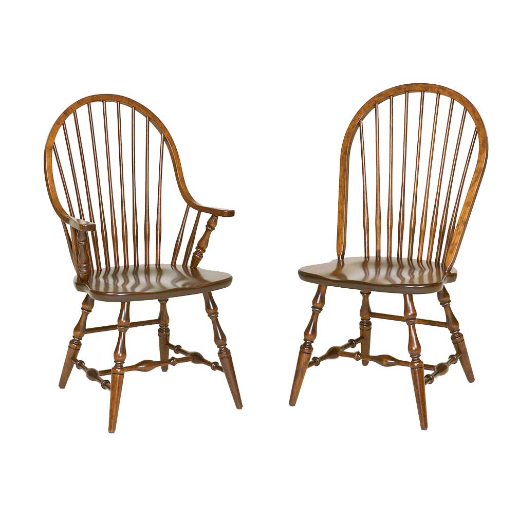 Two wooden spindle-back dining chairs with turned legs and stretchers, shown from the front on a plain white background.