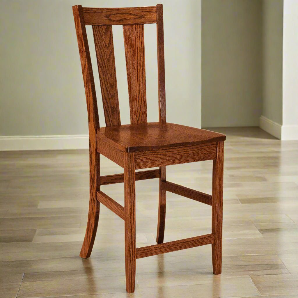 Oak counter height chair with a wide center splat, flared back posts, saddle seat and footrest rungs