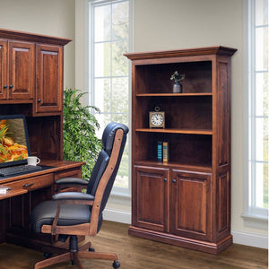 Six foot bookcase with two raised panel doors below three open shelves, next to a desk in a bright office