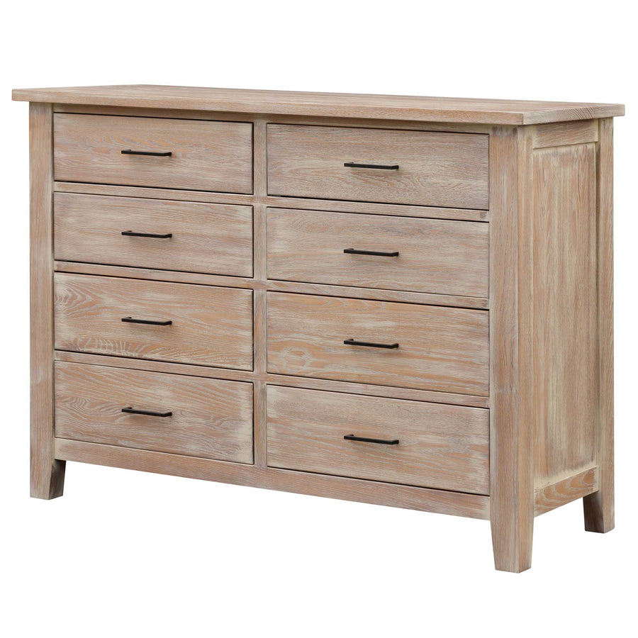 Whitewashed oak eight-drawer dresser with black bar pulls and paneled sides on a white background
