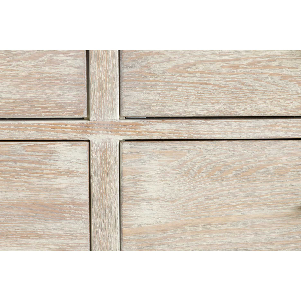 Detail of cerused whitewashed oak drawer fronts showing open grain texture and crisp drawer reveals