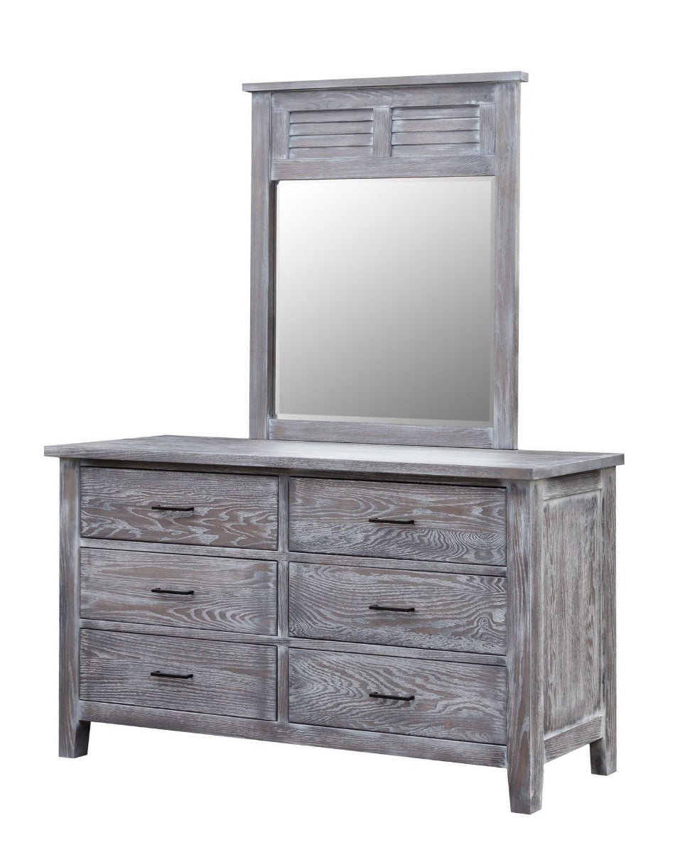 Oreland louver mirror standing on a gray six-drawer dresser with black bar pulls